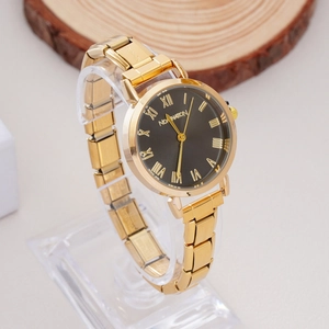 Detail of elegant gold metal watch featuring black dial with Roman numerals and brand logo