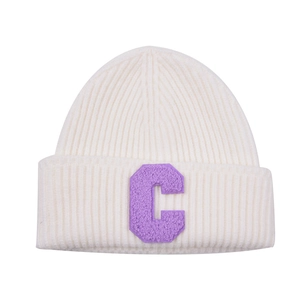 Detailed view of cream ribbed knit beanie with purple chenille patch letter C