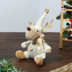 Detail of plush Christmas reindeer ornament with beige knit hat and golden accents