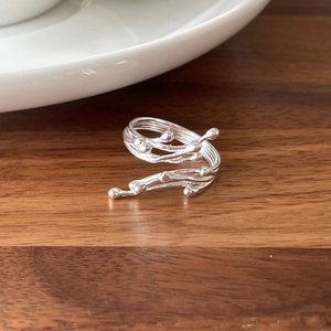 Detailed close-up of a silver 925 adjustable ring with irregular organic branch design