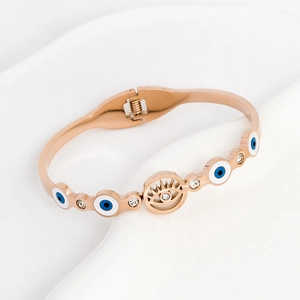 Rose gold titanium steel evil eye bangle with sparkling white stones on white background