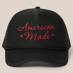 Detail of red American Made embroidery and stars on a black mesh trucker cap