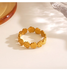 Detail of 18K gold plated flower rings with continuous floral pattern and vintage texture