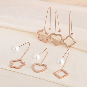 Detail of rose gold heart, square and flower earrings with pearls and crystals
