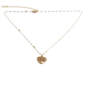 Golden stainless steel heart pendant necklace with tree of life filigree on white background