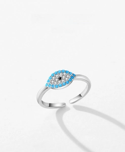 Macro detail of silver evil eye adjustable ring with turquoise and clear zircons