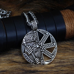 Macro shot of silver Viking Yggdrasil pendant on leather and brown fur background