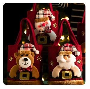 Detail of Christmas gift bags featuring plush Santa, snowman, and reindeer characters