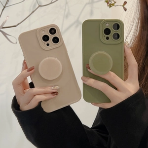 Close-up of beige silicone iPhone case featuring a functional round folding kickstand