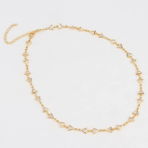 Detail of gold-plated necklace featuring triangular zirconia charms with lobster clasp