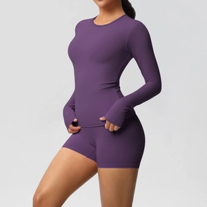 Detail of deep purple yoga set showing thumb hole cuffs and high waist athletic shorts
