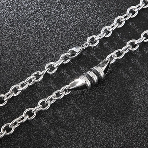 Macro shot of silver titanium O-chain necklace with a bullet-shaped spring clasp detail