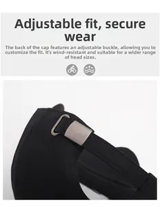 Close-up of adjustable metal buckle on black cotton twill baseball cap for custom fit