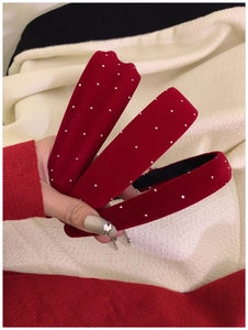 Detail of red velvet headband with sparkling rhinestones and thick retro padded design