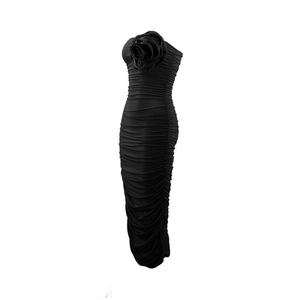 Detailed view of the 3D floral decoration and ruched texture on a black tube dress