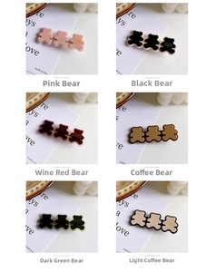 Detail of colorful resin bear hair clips with gold edging in six elegant shades