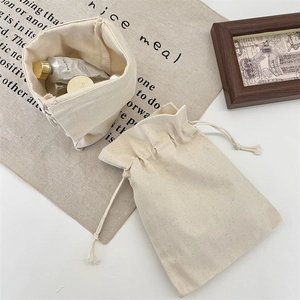 Creamy canvas drawstring storage bags set for organizing cosmetics and travel essentials