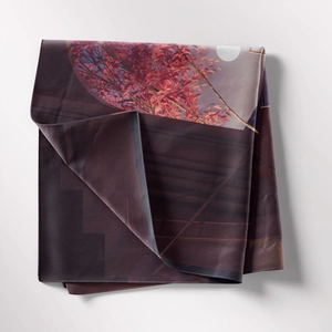 Detail of artistic tapestry fabric showing red maple trees and moon pattern textures