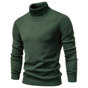 Detailed close-up of dark green turtleneck sweater with premium ribbed cuffs and hem