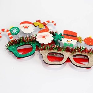 Close-up of assorted glittery Christmas glasses with festive tinsel and colorful frames