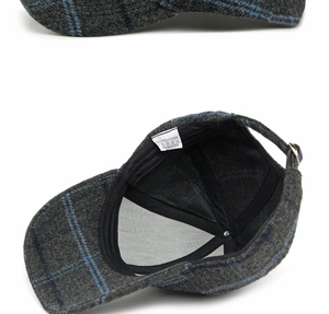 Detail of grey plaid baseball cap showing inner lining, sweatband and material label