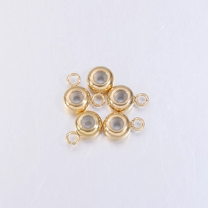 Close-up of gold-plated stainless steel slider beads with loops for DIY jewelry making