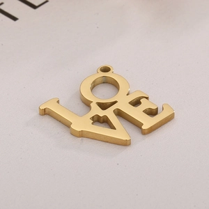 Macro detail of polished gold LOVE letter pendant with smooth mirror finish and bail