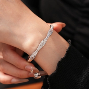 Macro shot of silver plated cross-line bangle with sparkling cubic zirconia pavé setting