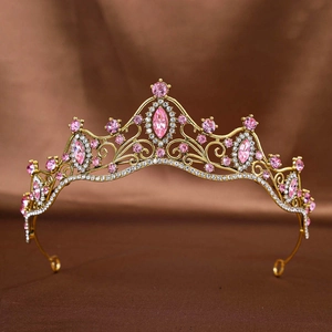 Detail shot of golden bridal crown featuring pink marquise rhinestones and crystals