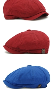 Close-up of retro newsboy caps in red and blue twill with metal button detail