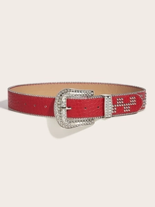 Detail of red crocodile texture belt with sparkling rhinestone buckle and silver rivets
