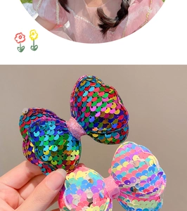 Detail of laser sequin bow hair clips for girls in vibrant rainbow and macaron colors