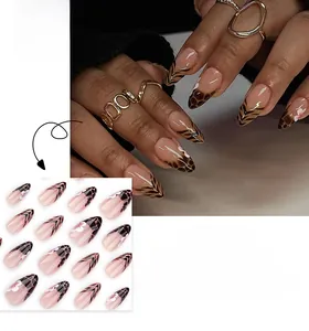 Detail showing almond-shaped press-on nails with leopard patterns and floral accents