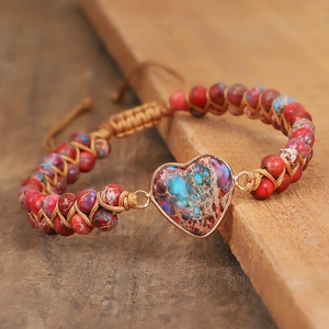 Detailed macro view of heart-shaped stone on a handmade braided wrap bracelet