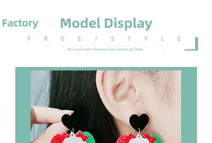 Close-up of model wearing vibrant Christmas heart earrings with red and green sequins