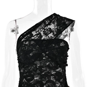 Detailed close-up of a black lace one-shoulder dress with floral patterns on a mannequin