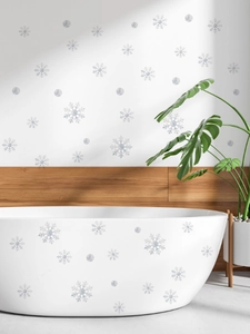 Self-adhesive white snowflake wall stickers applied on modern bathroom walls and bathtub