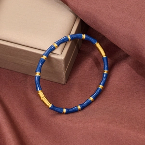Detail of bamboo joint bracelet with blue enamel inlay and secure metal clasp