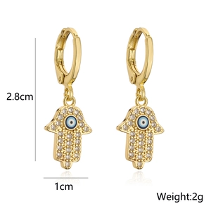 Detailed view of 18K gold Hamsa hand earrings with Evil Eye zircon inlay and 2.8cm height