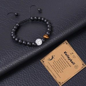 Close-up of matte volleyball beaded bracelet with tiger eye stone on a motivational card