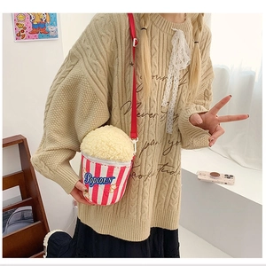 Cute popcorn bucket plush crossbody bag with red stripes for kids shown on a model