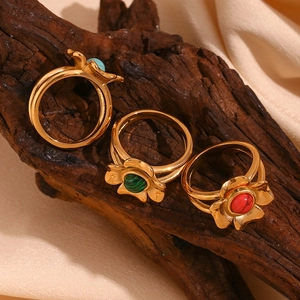 Retro 18K gold plated flower rings with turquoise, green and red gemstones on wood