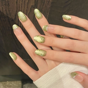 Handmade cat eye press-on nails in grass green with hand-painted floral and pearl details