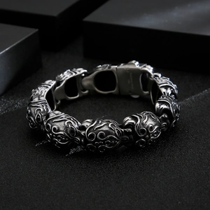 Detail of vintage embossed tribal flame patterns on silver stainless steel bracelet