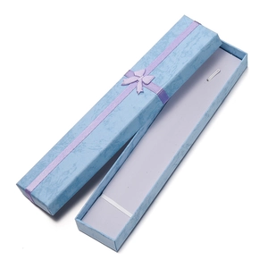Macro view of blue marble pattern jewelry box with a purple ribbon bow detail