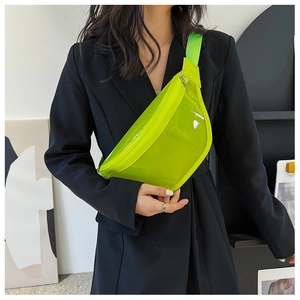 Detail showing neon translucent PVC chest bag with wide woven strap and zipper on model