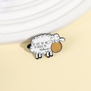 Cartoon sheep enamel brooch with Matthew 18:12 scripture quote on warm cream background