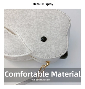 Gros plan d'un mini sac blanc en forme d'oiseau avec texture litchi et zip en métal