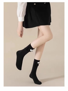 Detail of black magnetic holding hands socks with cute 3D eyes on ribbed knit cotton