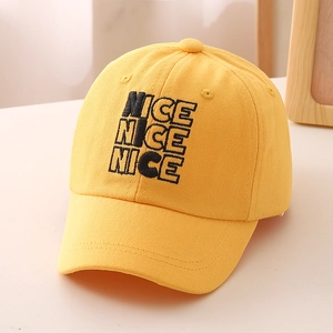 Detail of 3D letter embroidery and premium cotton stitching on kids yellow baseball cap